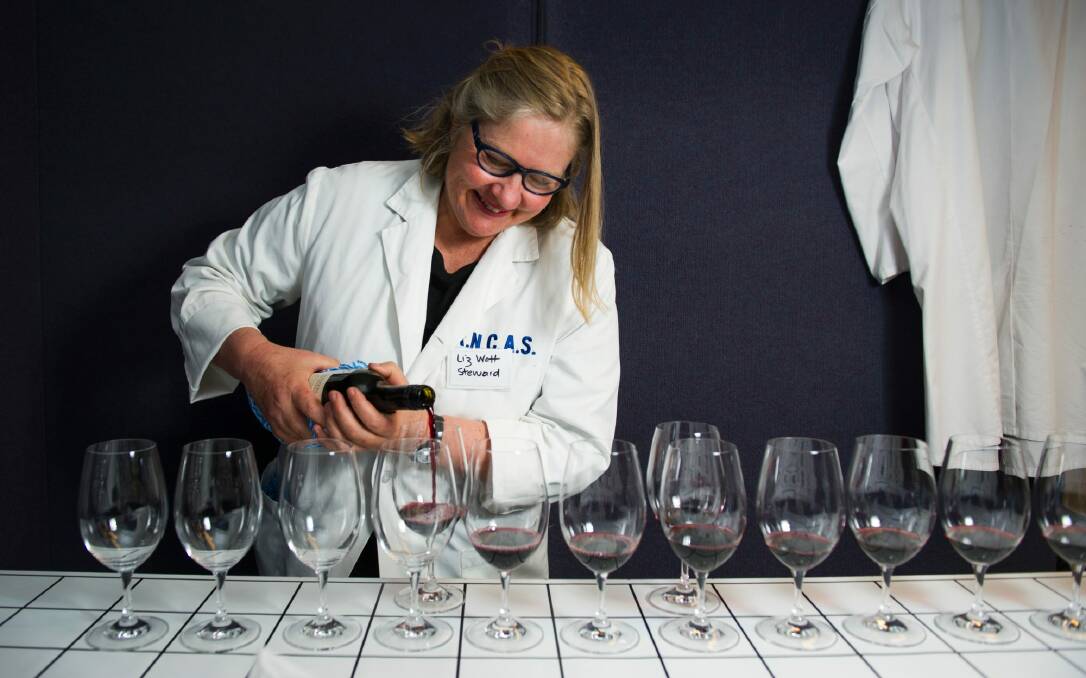 Wine steward Liz Watt sets up for the judging at the Canberra Wine Show.  Photo: Elesa Kurtz