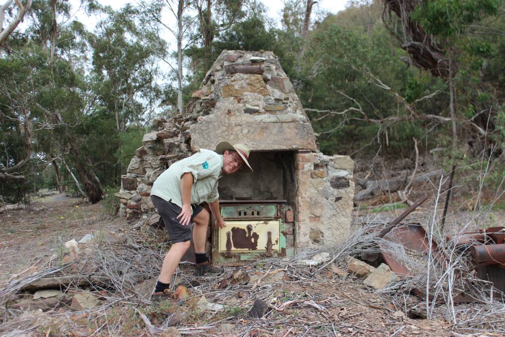 Tim checks out the remains of an old stockmans cottage near Silver Wattle. Photo: Justin Bush