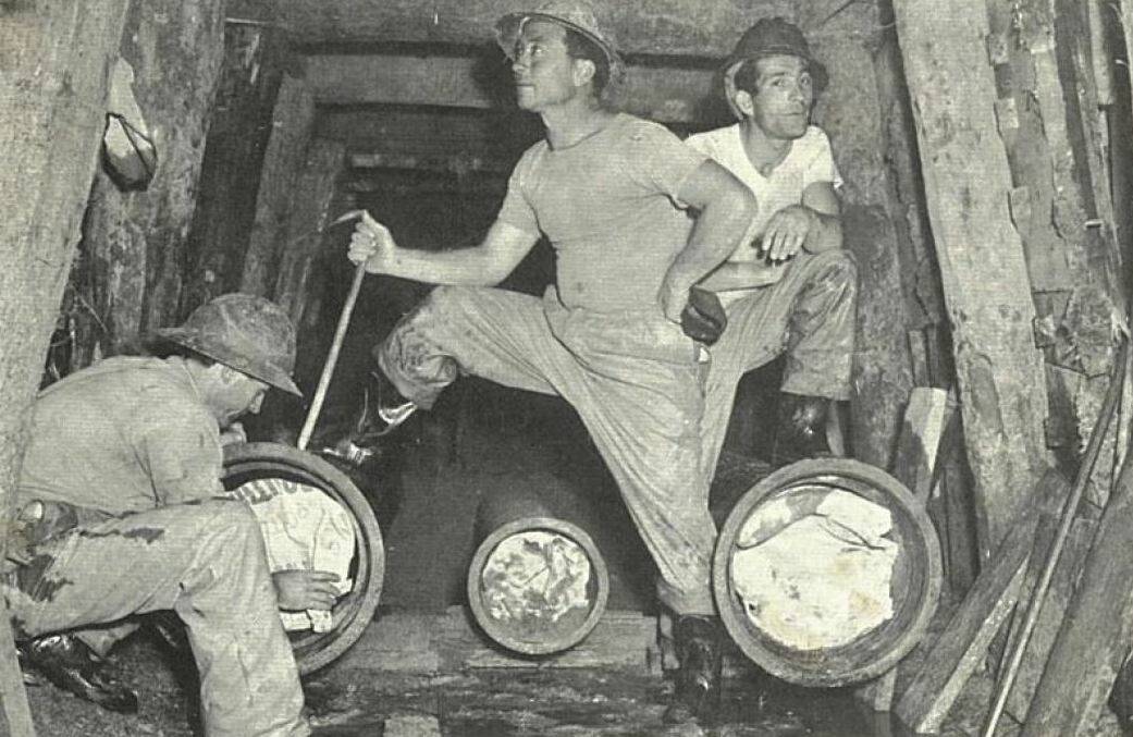 Sebastiano Mammoliti (back right) working in a tunnel leading from the old Canberra hospital in Acton towards Parliament House, circa 1955.  Photo: Supplied by Joe Mammoliti