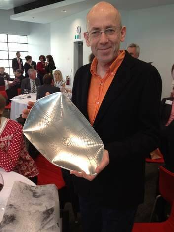 Morris Gleitzman with his alumni excellence award which features the original Burley Griffin map of Canberra. Photo: Supplied