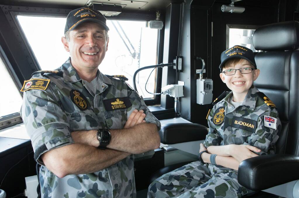 Captain John Stavridis with Honorary Lieutenant Daniel Blackman on the bridge of HMAS Hobart.  Photo: POIS Phil Cullinan
