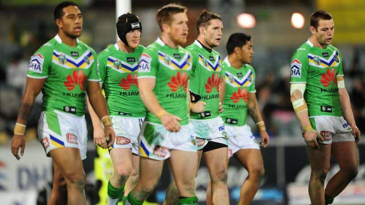 Dejected  Raiders players contemplate their 34-18 loss to the Rabbitohs  on Monday night. Photo: Melissa Adams