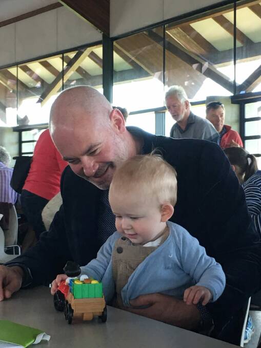 Anthony Toms, partner of Andrew Barr, entertains Andrew Barr's nephew, Angus, 10 months. Photo: Kirsten Lawson