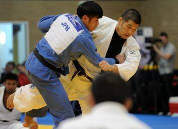 Japanese Judo expert Kosei Inoue, an Olympic gold medalist from the Sydney games, and head coach of the Japanese team, right, gives a demonstration to Judo exponents at the AIS Combat Centre. Photo: Graham Tidy