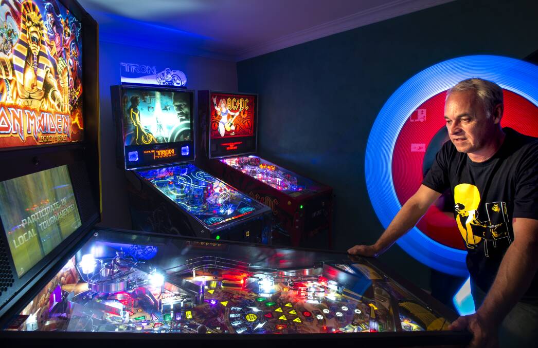 ACT Pinball Championship organiser Peter Menzel at home with his new Iron Maiden machine.  Photo: Sitthixay Ditthavong