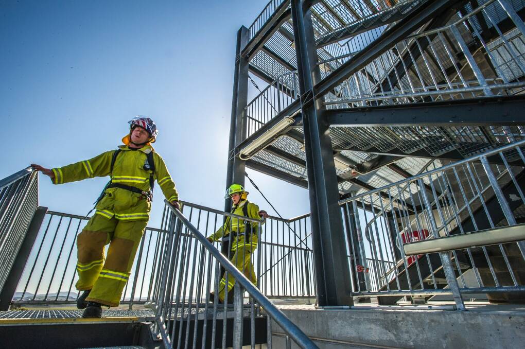 ACT Firefighters Matt Buchtmann and Kari Harlovich are among five ACT firefighters who will be running up and down Sydney Tower in their full gear to raise money and awareness for Motor Neurone Disease. They are training at the Hume training facility. Photo: Karleen Minney