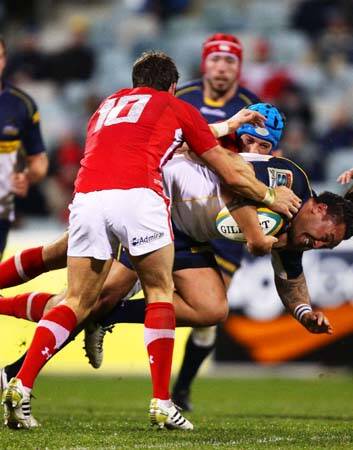 Fotu Auelua of the Brumbies feel the full grunt of the Wales defence. Photo: Getty Images