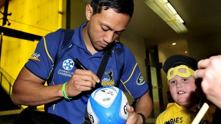 Homecoming: Christian Lealiifano greets a fan after arriving back in Australia. Photo: Melissa Adams