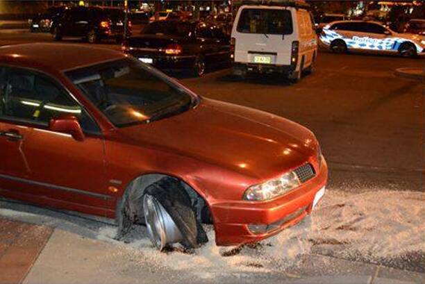 A red Mitsubishi Magna crashed into the Dickson Library Tuesday night. Photo: Supplied
