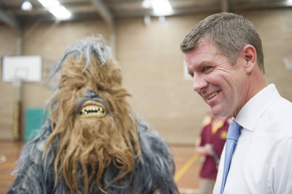  NSW Premier Mike Baird, at the Queanbeyan basketball centre, The Den, with the basketball association's mascot, a hairy yowie.
 Photo: Jay Cronan