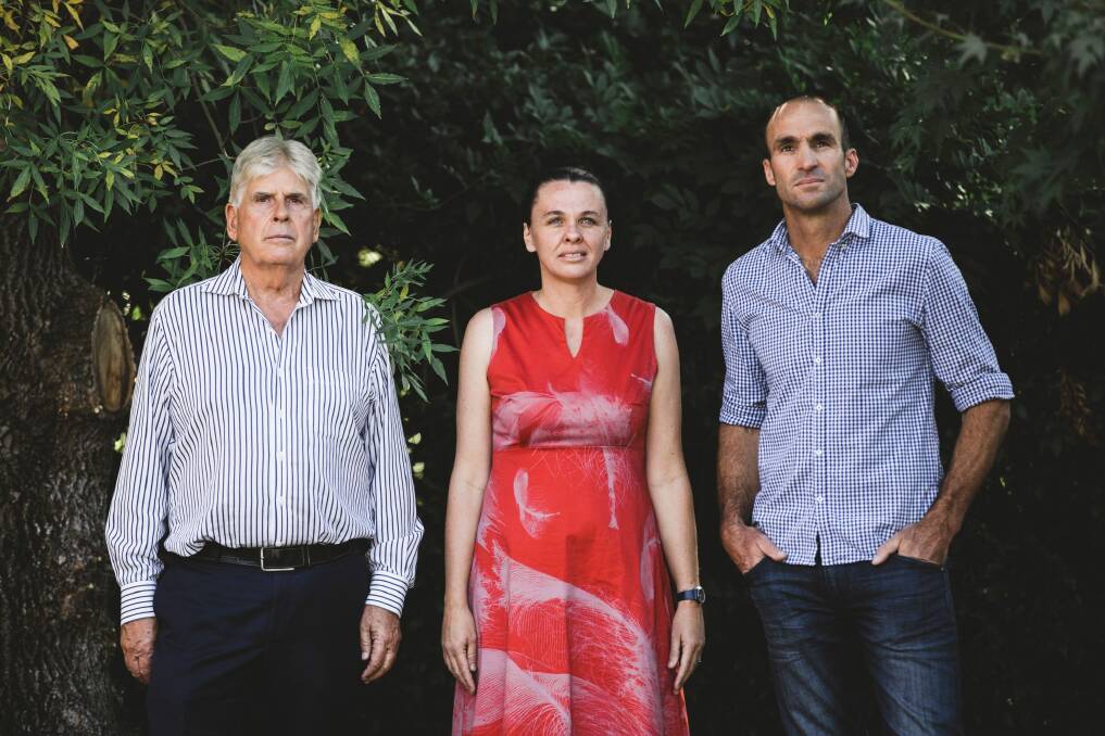 Jim Bain, Natasha Knowles and Mark Taylor, who bought blocks in Forrest with a view to developing them one day, say the NCA's new proposal will shave value off their properties. Photo: Jamila Toderas