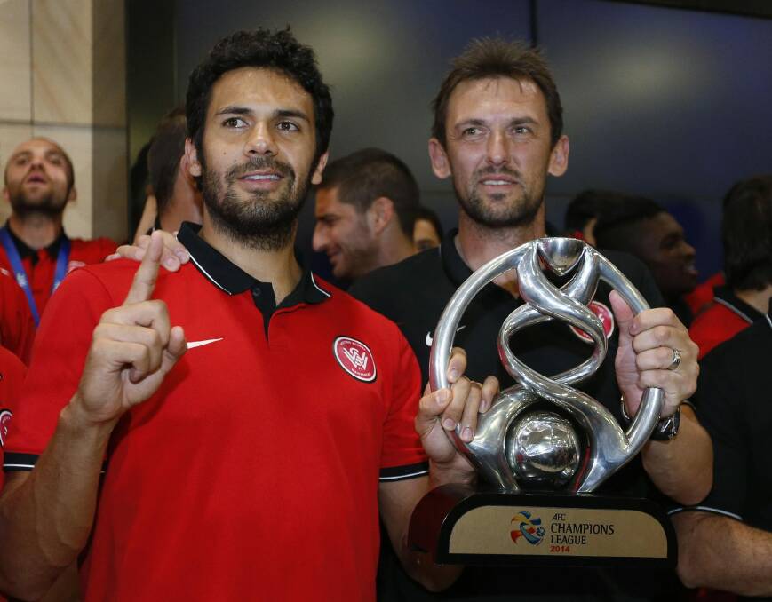 Nikolai Topor-Stanley (left) and Wanderers coach Tony Popovic after winning the Asian Champions League. Photo: Reuters