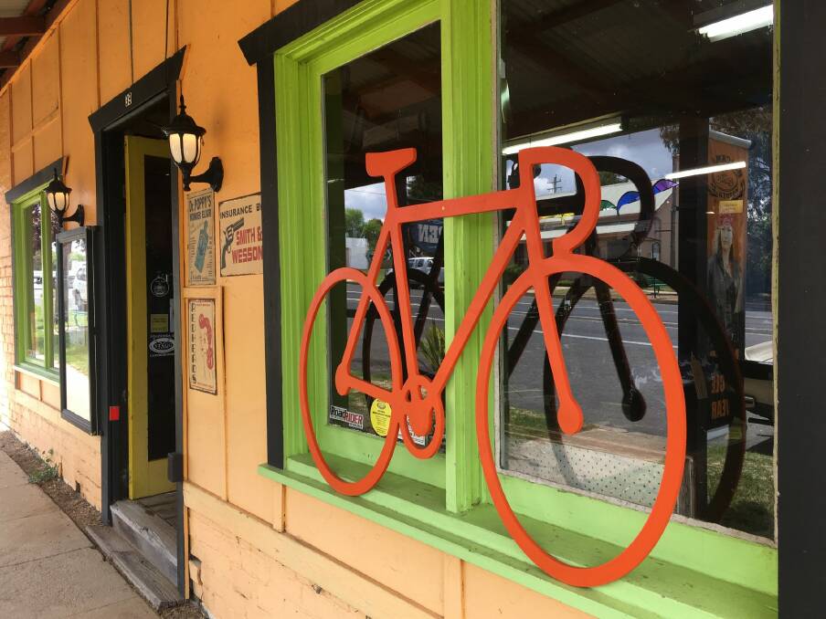 One of the many orange bike cut-outs appearing in shop windows around the region in support of the Monaro Rail Trail. Photo: Tim the Yowie Man