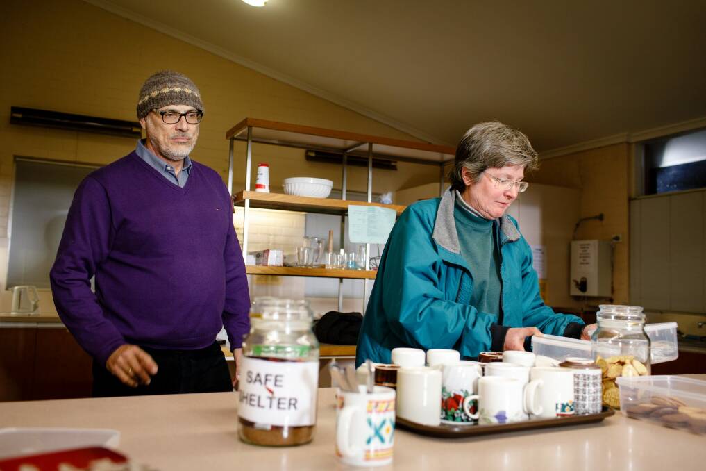 Safe Shelter volunteers Ken Vesperman, left, and Katy Nicholls prepare hot drinks at St Columba's Uniting Church in Braddon for homeless people looking for shelter this week in Canberra. Photo: Sitthixay Ditthavong