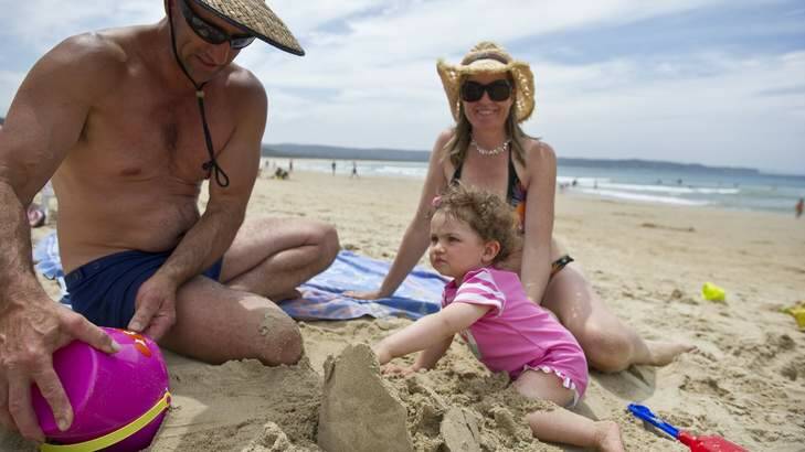 Sunny summer times in Tathra being enjoyed by holiday makers Anthony Moore, daughter Holly Moore 13 months and mother Jo Stuart. Photo: Jay Cronan