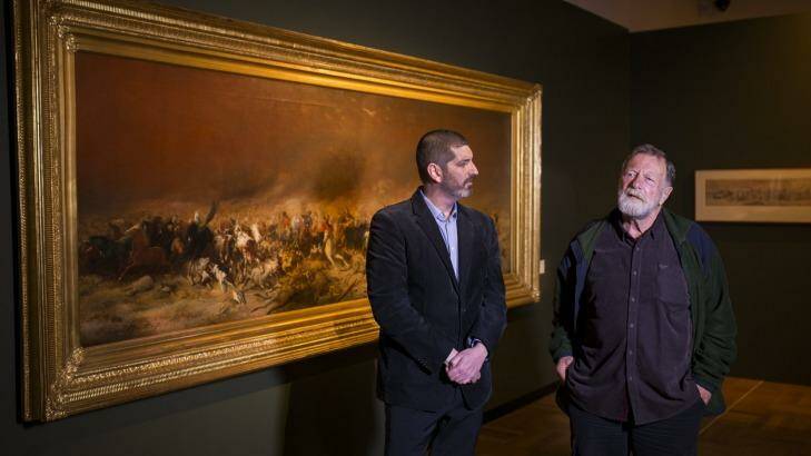 Currator Matthew Jones talks with actor Jack Thompson in front of Black Thursday at the launch the National Library of Australia's new exhibition Heroes and Villains: Strutt's Australia. Photo: Rohan Thomson
