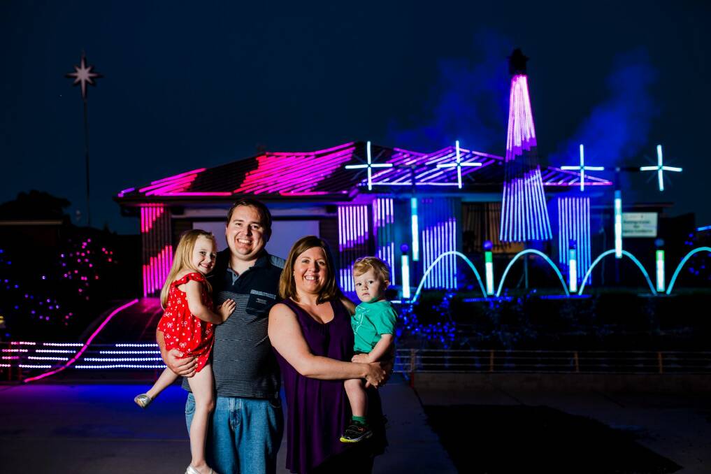 James Petterson with his wife Sarah, and children Rachel 4, and Andrew 1. The Petterson's light installation has more than 30,000 LED bulbs. Photo: Jamila Toderas