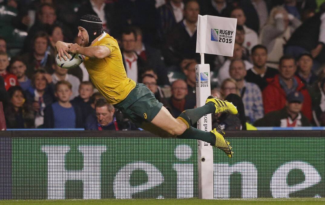 Australia's Matt Giteau scores his side's third try during the Rugby World Cup Pool A match between England and Australia. Photo: AP