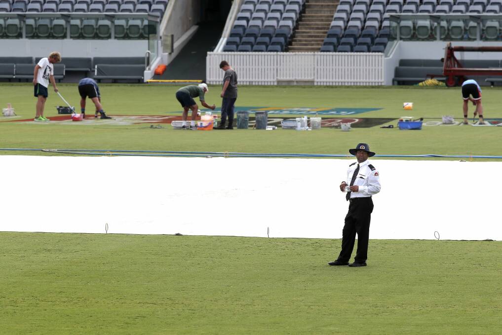 A security guard next to the pitch at Manuka Oval on Sunday ahead of the first Canberra game of the Cricket World Cup. Photo: Jeffrey Chan