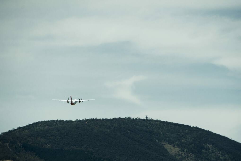 A plane departs Canberra, viewed from the airport tower.
 Photo: Jay Cronan