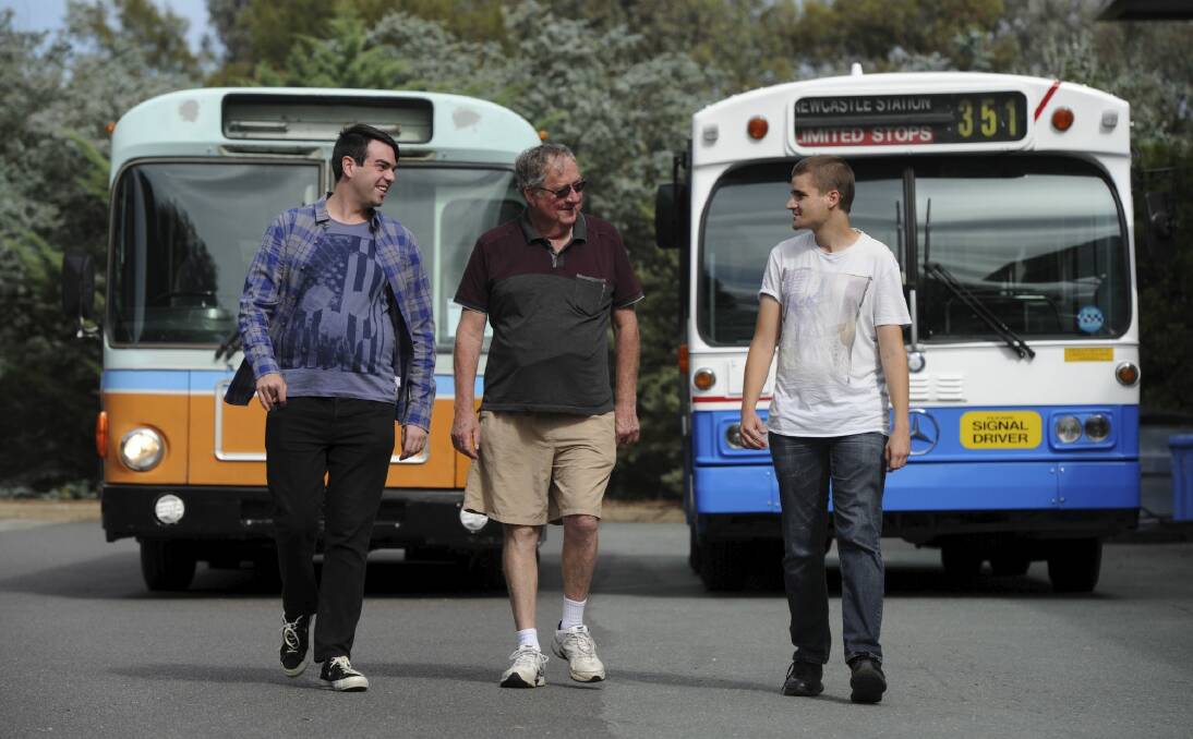 Heritage officer of the Retired ACT Transport Employees Club Todd Milton, club president Ian Baker and Watson-resident Kyle Threlfo with two buses that are being restored. Photo: Graham Tidy