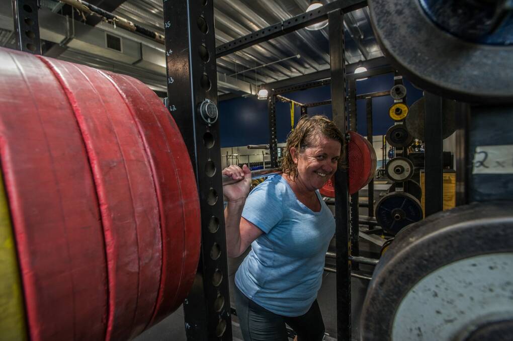 200 club challenge: Karen Hardy has a go at lifting a 200kg barbell. Photo: Karleen Minney