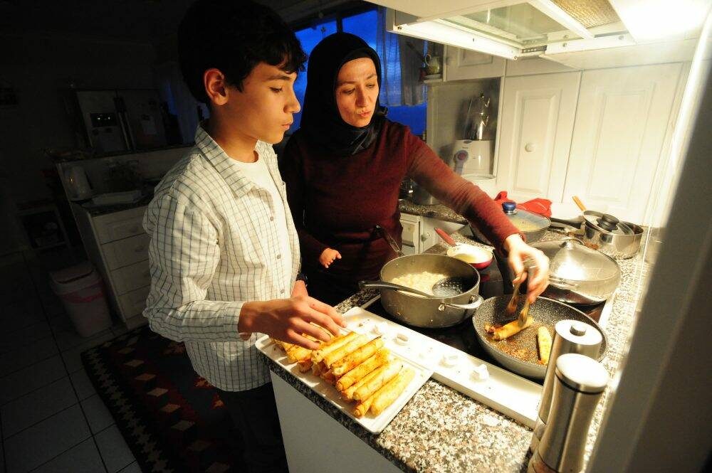Handan Erdogan and her son Seyfullah, 14, prepare the evening feast. Photo: Karleen Minney