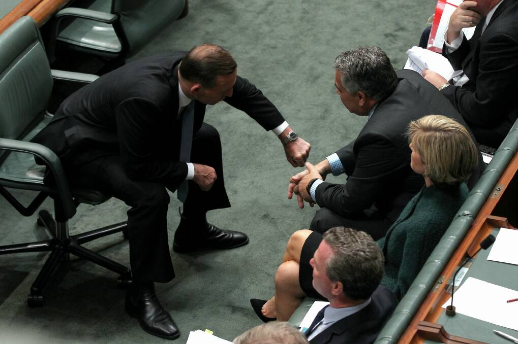 Prime Minister Tony Abbott shows Treasurer Joe Hockey the time. Photo: Alex Ellinghausen