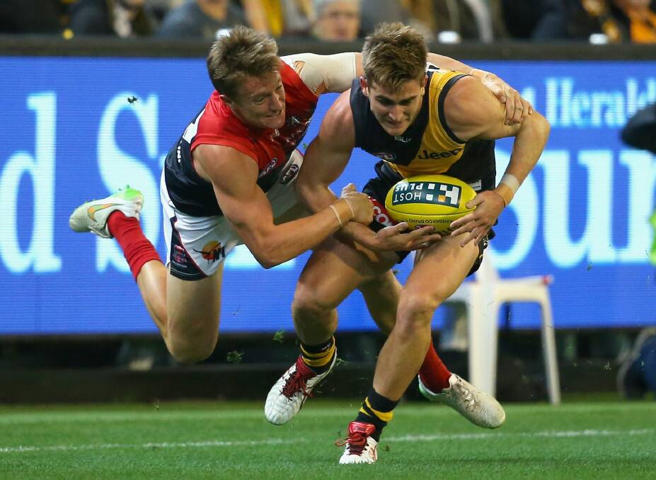 Former Ainslie midfielder Aaron vandenBerg tackles Richmond's Anthony Miles.
 Photo: Getty Images