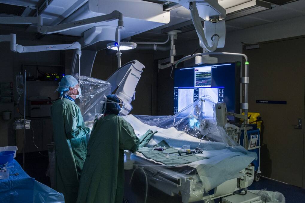 Surgeons work on a patient in Canberra Hospital's new Cardiac Catheterisation Laboratory. Photo: Rohan Thomson