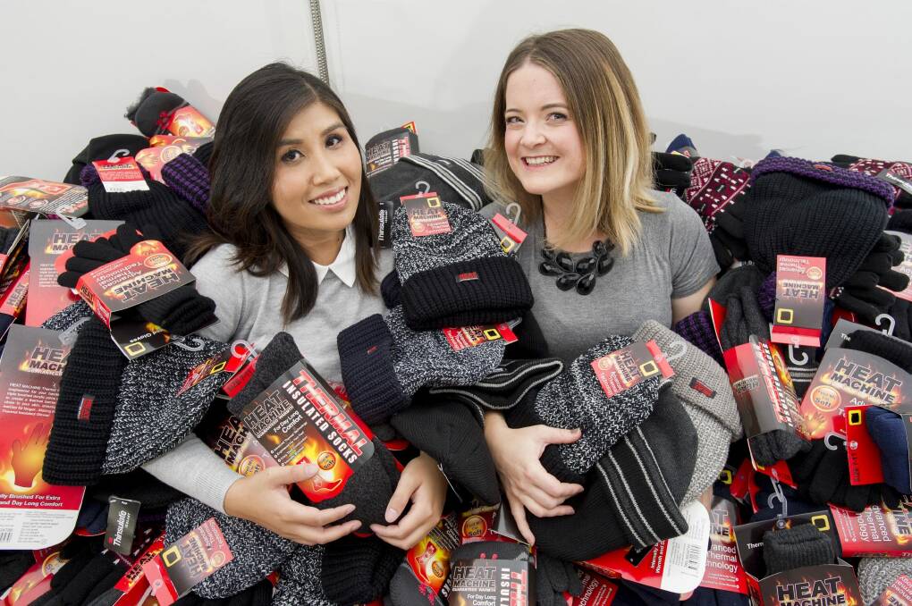 Canberra mothers Soudalay Thammavongsa, left, and Emma Madsen with hundreds of thermal socks for the homeless. Photo: Jay Cronan
