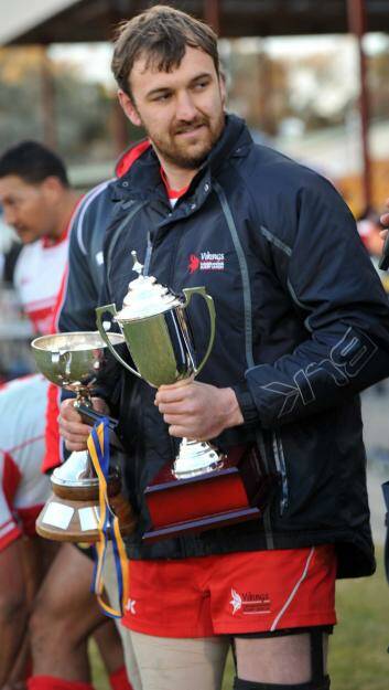 Tuggeranong captain Gareth Clouston with the premiership trophy. Photo: Graham Tidy