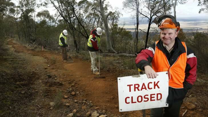 Track specialists Mike Long and Chris Short with Makin Trax managing director Darren Stewart (front) working on the Canberra Centenary Trail on Mount Ainslie. Photo: Jeffrey Chan