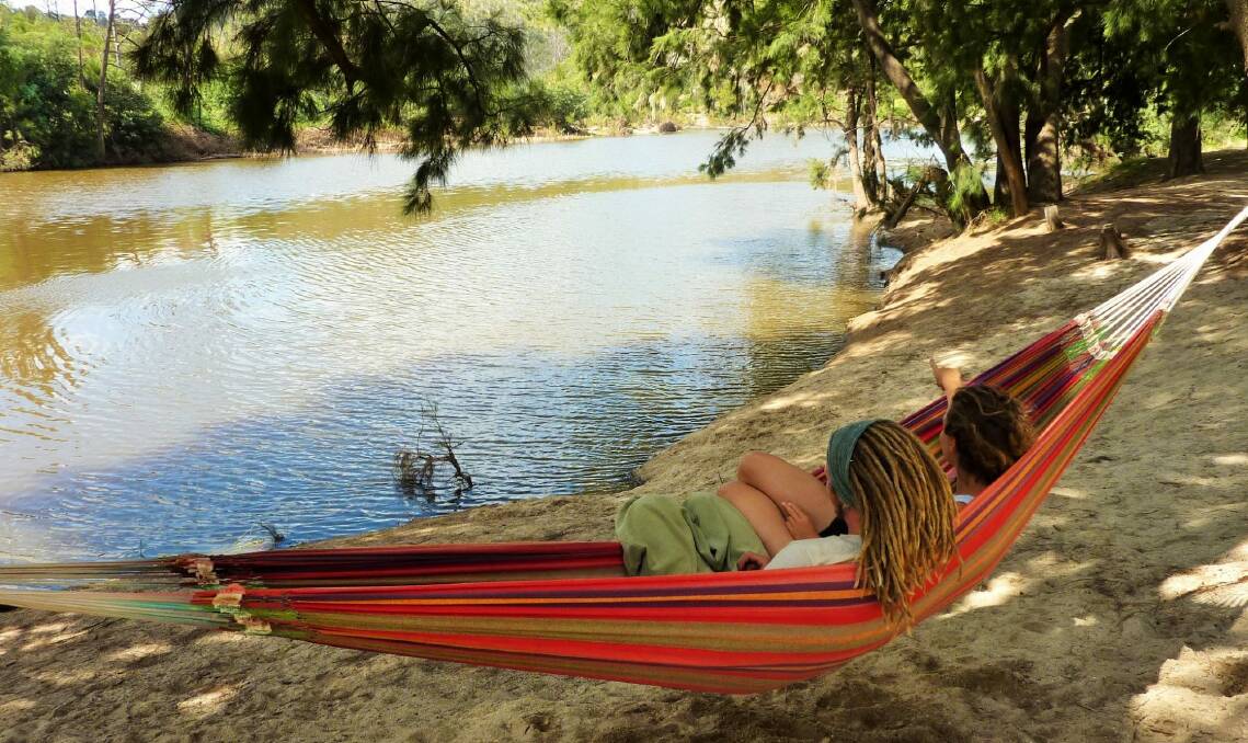 With record high water temperatures, this week it's almost cooler swinging in a hammock than splashing in the water at Casuarina Sands, one of several popular swimming holes along the Murrumbidgee River in Canberra. Photo: Tim the Yowie Man