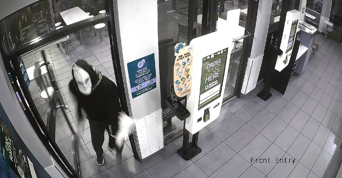 A still from CCTV footage of a man wanted by ACT Police in relation to an aggravated robbery on Monday. Photo: ACT Policing