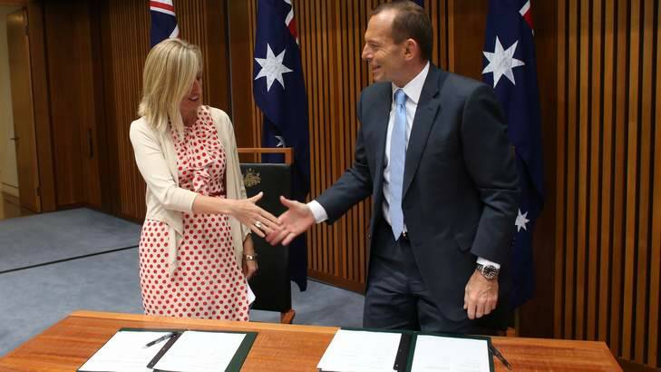 Prime Minister Tony Abbott signs a environmental planning MOU with ACT Chief Minister Katy Gallagher. Photo: Andrew Meares