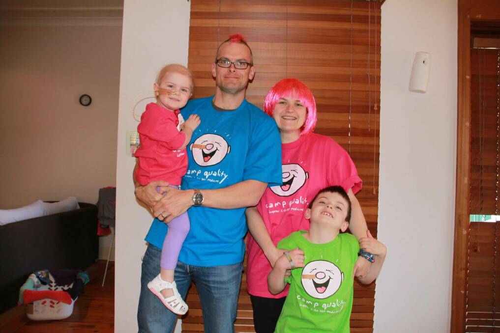 Annabelle and Oliver with parents Cristy and David, who created humorous hairstyles to keep their children laughing. Photo: Supplied
