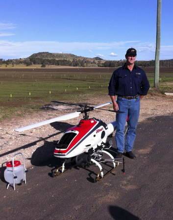Greg Harris with an RMAX unmanned helicopter that he is leasing for weed spraying. Photo: Supplied