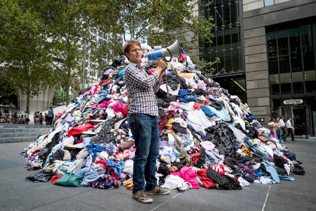 The Chaser's Craig Reucassel dumps six tonnes of 'fashion waste' in Sydney's Martin Place - to show the volume of clothes going to landfill in Australia every 10 minutes. Photo: Ben King/ABC