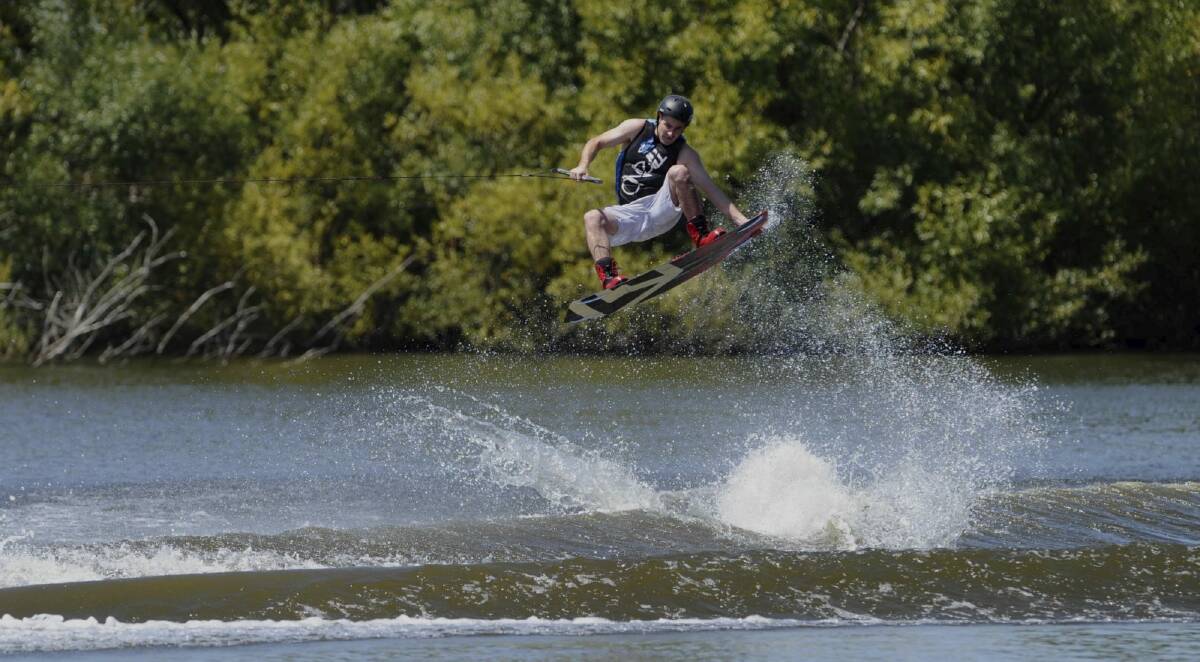 Leigh Baguley of Lyneham, cools off on Sunday, enjoying a run on his wakeboard, in the Molonglo River.  Photo: Graham Tidy