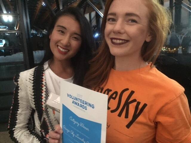 Orange Sky Laundry Canberra service manager Noreen Vu and volunteer Rebecca Butchart with the volunteering award won by the mobile laundry service for homeless people. Photo: Supplied