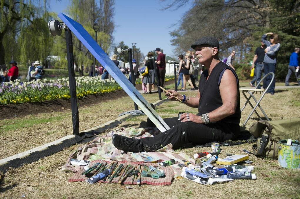 It's painter Michael Fitch's 13th year painting the Floriade scenery. Photo: Jay Cronan