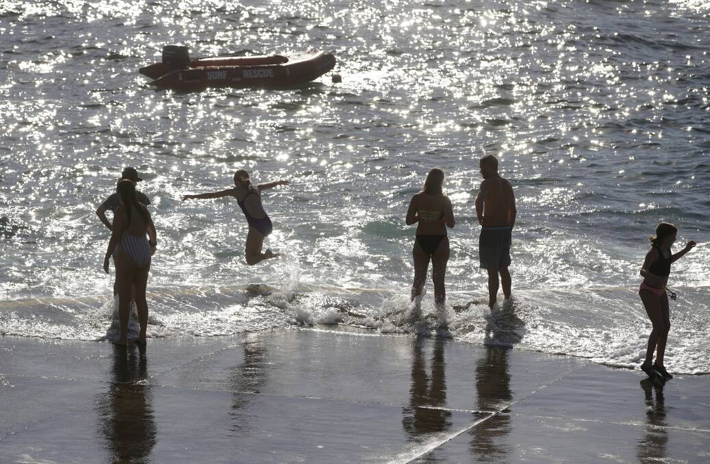 Beachgoers took to the water at Clovelly to beat Sunday's stifling heat. Photo: Ben Rushton