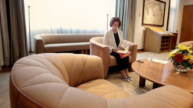 Prime Minister Julia Gillard sorts through her paperwork in her office at Parliament House. Photo: Alex Ellinghausen