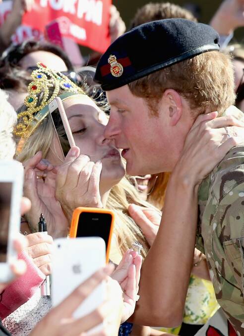 When Harry met Vicky: Prince Harry is kissed by royal fan Victoria McRae during a walkabout outside the Sydney Opera House. Photo: Getty Images