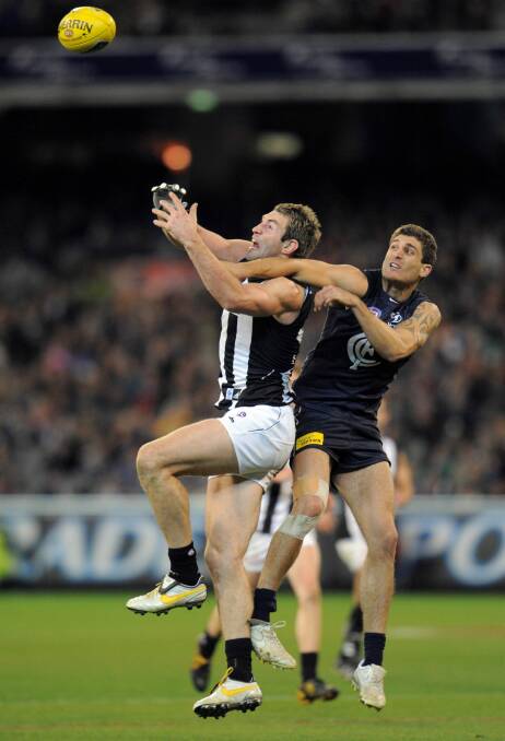 AFL football . Collingwood v Carlton at MCG . Travis Cloke and Paul Bower. .   Friday 24th July   2009. THE AGE SPORT. Picture by Vince Caligiuri . Photo: Vince Caligiuri