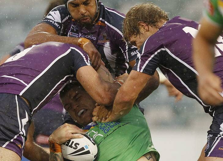 Josh Dugan of the Canberra Raiders is tackled during the round one NRL match between the Canberra Raiders and the Melbourne Storm at Canberra Stadium on Saturday. Photo: Stefan Postles