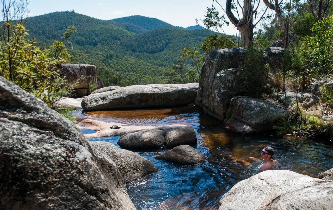Luke Clarke of Calwell cools off in the rock pools at Gibraltar Falls during the continued hot weather. Photo: Elesa Kurtz