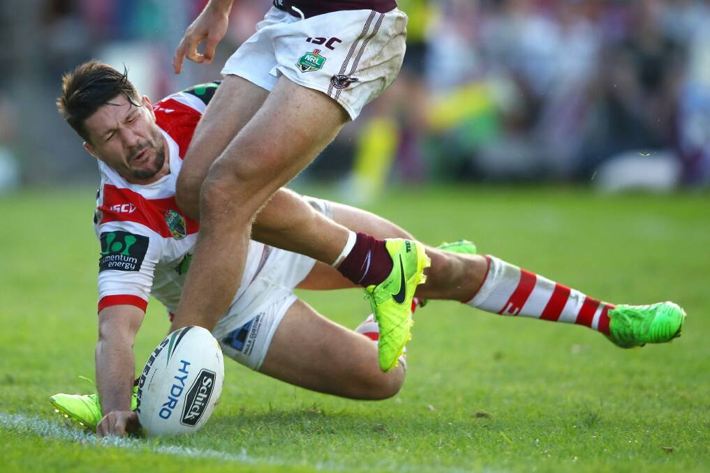 Involved in early controversy: Gareth Widdop pounces to score one of his two tries. Photo: Getty Images