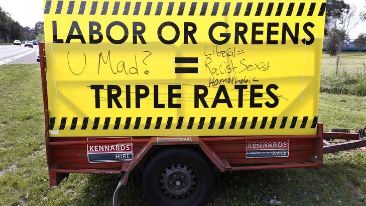 Graffiti on a Canberra Liberals campaign sign along Parkes Way. Photo: Jeffrey Chan